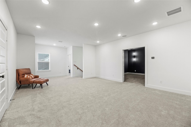 living area featuring light colored carpet