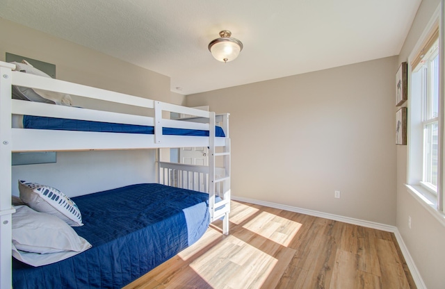 bedroom with hardwood / wood-style flooring