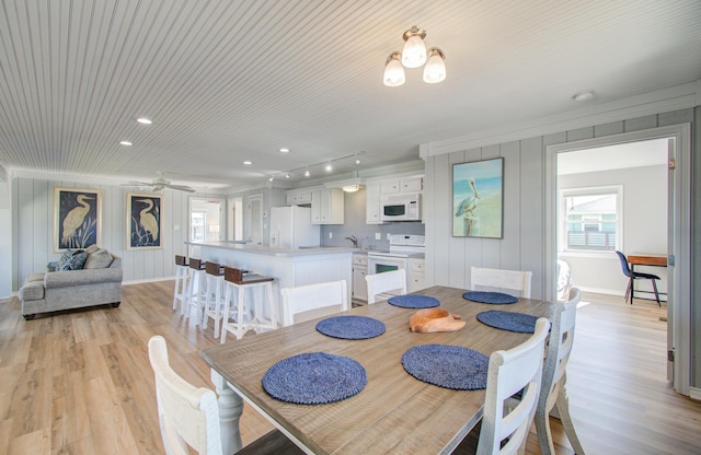 dining area with light wood finished floors and baseboards