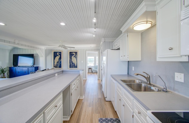 kitchen with white cabinetry, sink, ceiling fan, and light hardwood / wood-style floors