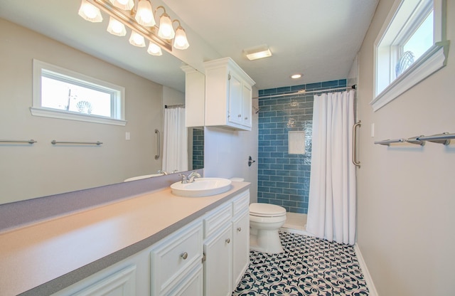 full bathroom featuring a tile shower, toilet, and vanity