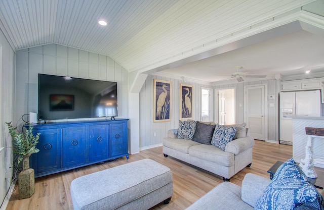 living room featuring ceiling fan, ornamental molding, vaulted ceiling, and light wood-type flooring