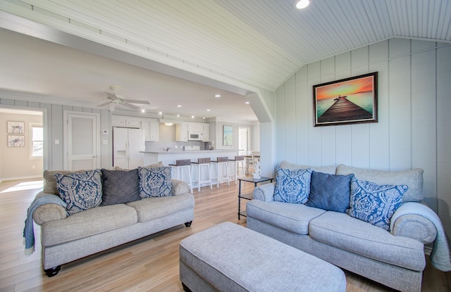 living room with ornamental molding, vaulted ceiling, ceiling fan, wooden ceiling, and light hardwood / wood-style floors