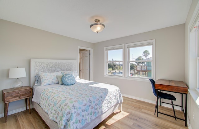 bedroom with baseboards and light wood-style floors