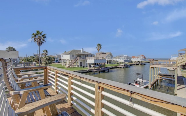 dock area featuring a balcony, a water view, and a residential view