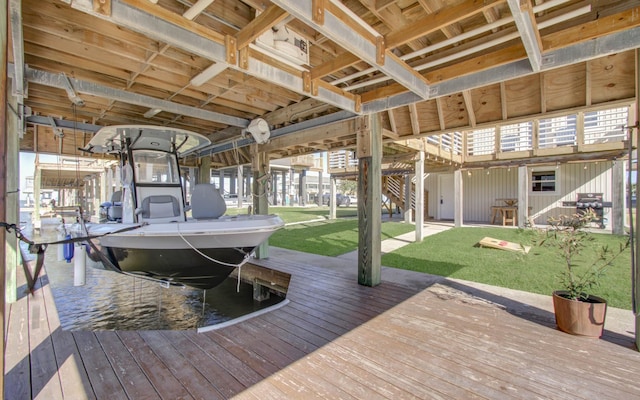 dock area with a lawn, a water view, and boat lift