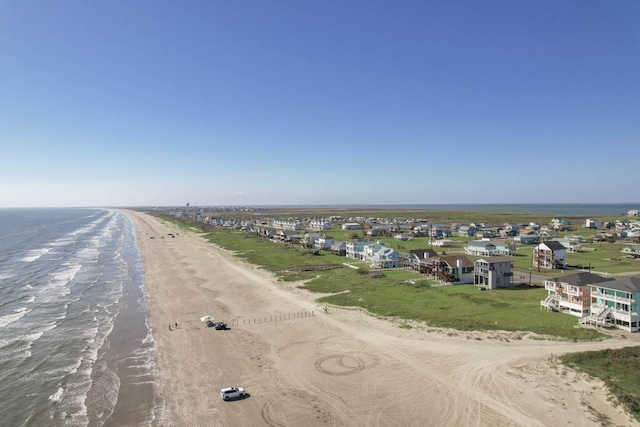 drone / aerial view featuring a water view and a beach view