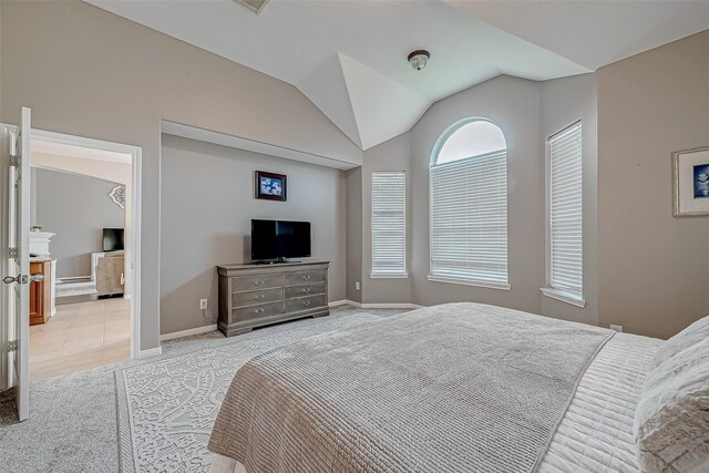 carpeted bedroom featuring vaulted ceiling and multiple windows