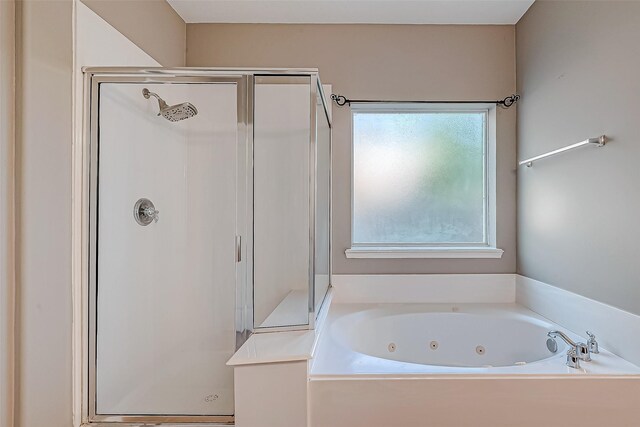 bathroom with shower with separate bathtub