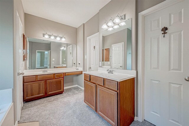 bathroom with vanity and a tub