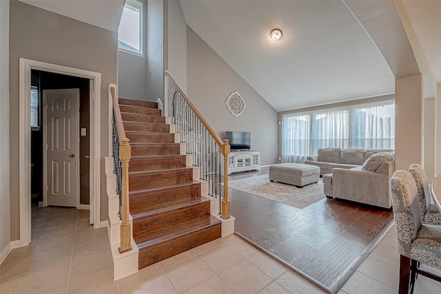 tiled living room with high vaulted ceiling