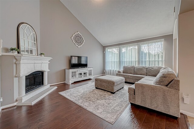 living room with vaulted ceiling and dark hardwood / wood-style floors