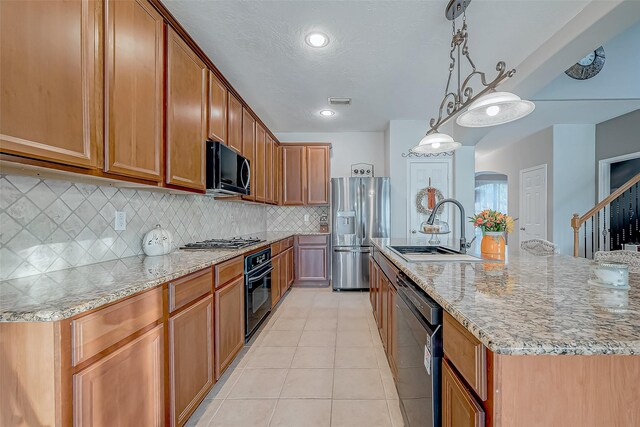 kitchen with sink, light tile patterned floors, backsplash, hanging light fixtures, and black appliances