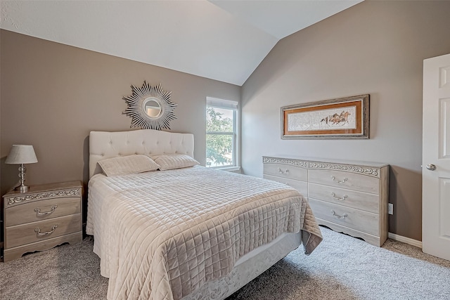 carpeted bedroom featuring lofted ceiling