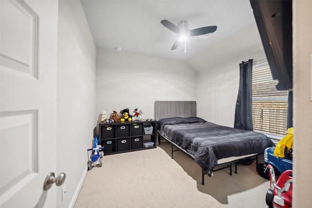 carpeted bedroom with ceiling fan and vaulted ceiling