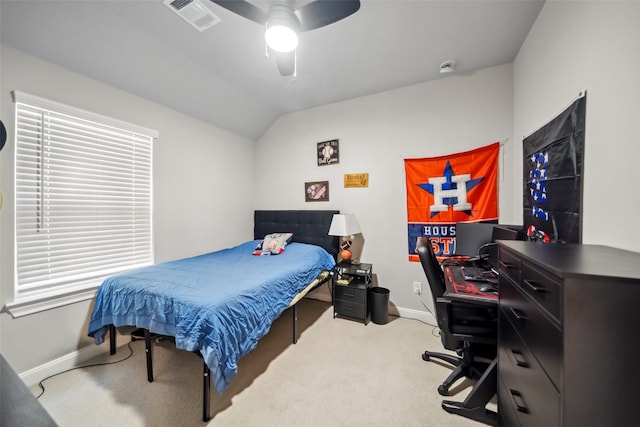 bedroom with ceiling fan, lofted ceiling, and light carpet