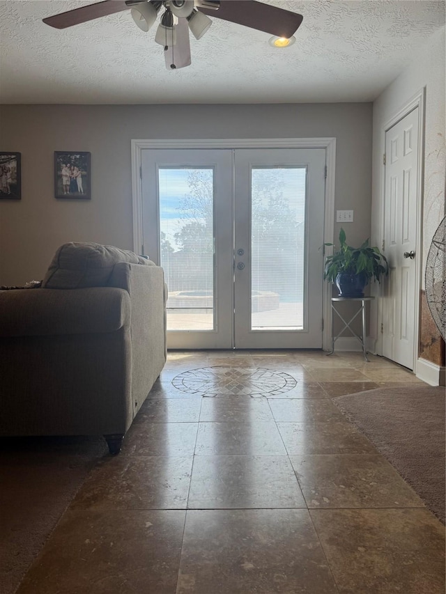 doorway featuring ceiling fan, a healthy amount of sunlight, a textured ceiling, and french doors