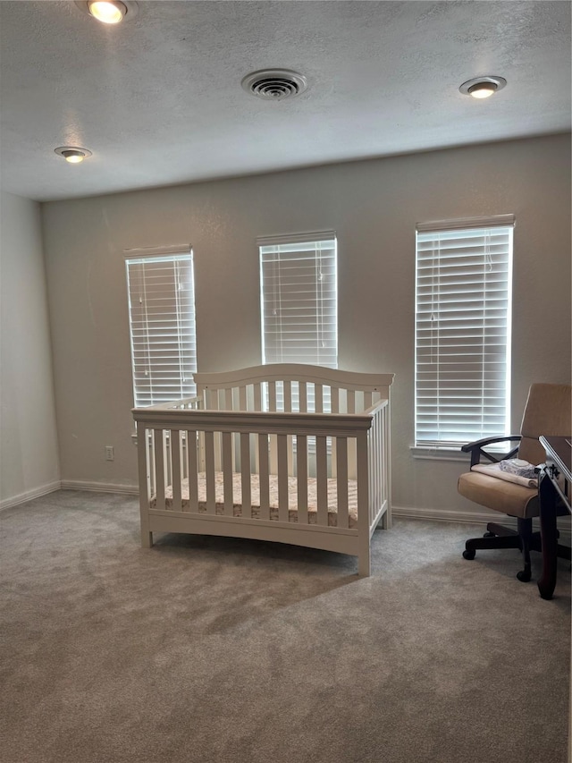 bedroom with light colored carpet and a crib