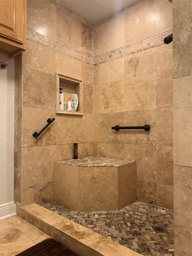 bathroom with a tile shower