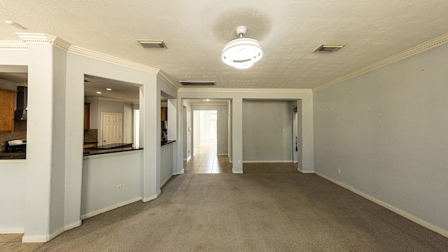 carpeted spare room featuring a textured ceiling and ornamental molding