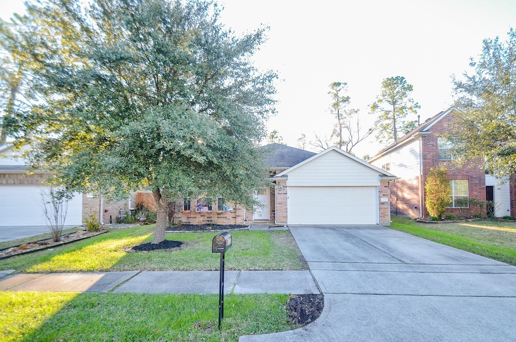 view of front of home with a garage and a front lawn