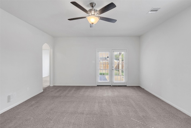 spare room featuring light carpet and ceiling fan