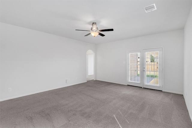 carpeted empty room featuring ceiling fan