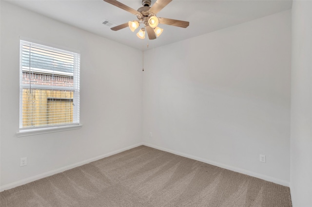 carpeted empty room featuring ceiling fan