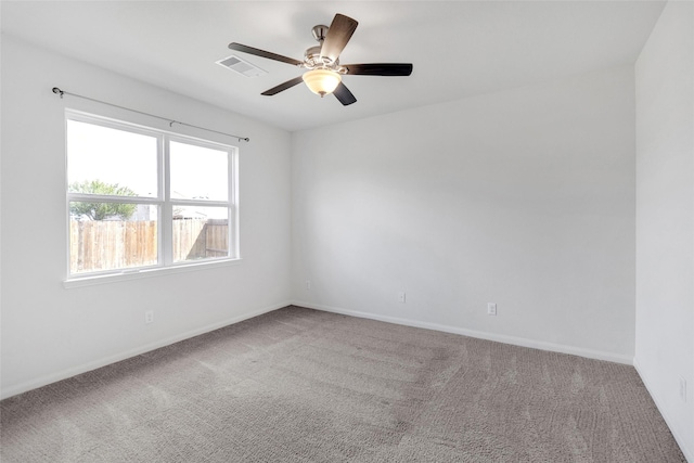 carpeted spare room featuring ceiling fan