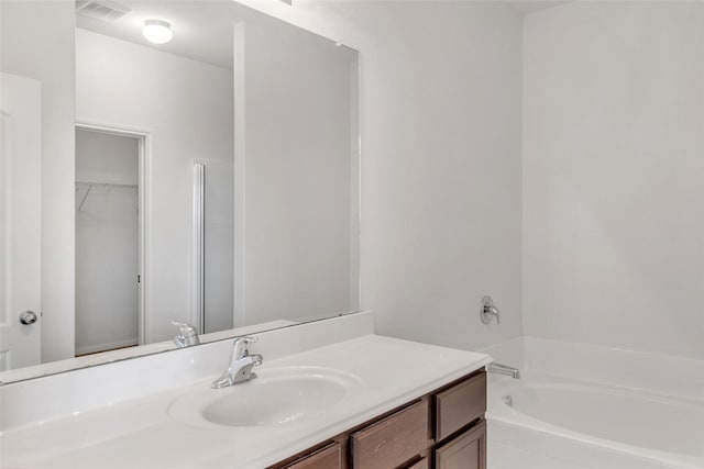 bathroom with a relaxing tiled tub and vanity