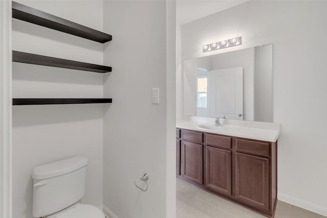 bathroom with tile patterned floors, vanity, and toilet