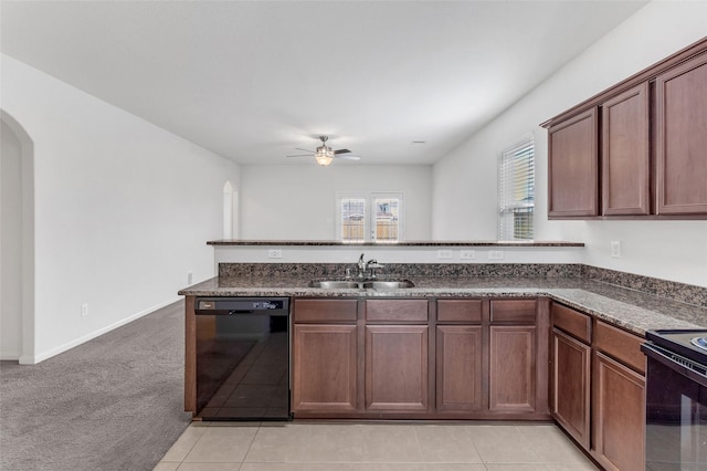 kitchen with sink, ceiling fan, black dishwasher, light colored carpet, and kitchen peninsula