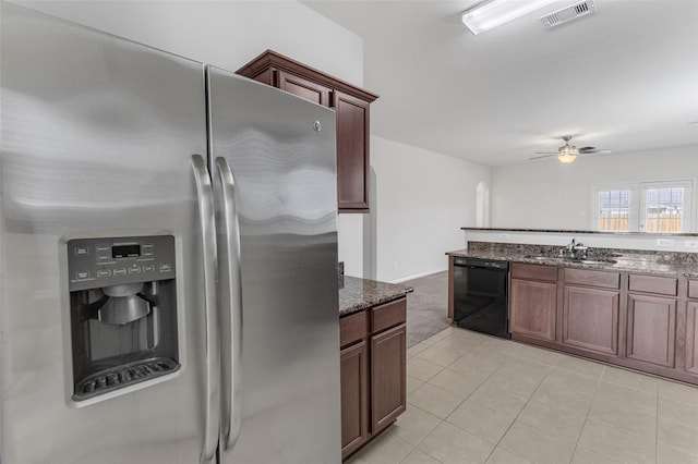 kitchen with dishwasher, sink, ceiling fan, dark stone countertops, and stainless steel fridge with ice dispenser