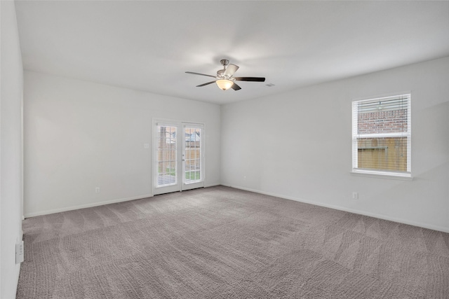 spare room featuring ceiling fan and carpet floors