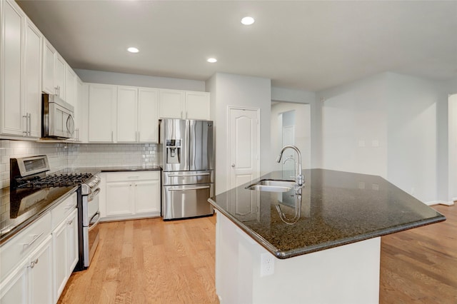 kitchen featuring white cabinetry, sink, an island with sink, and stainless steel appliances