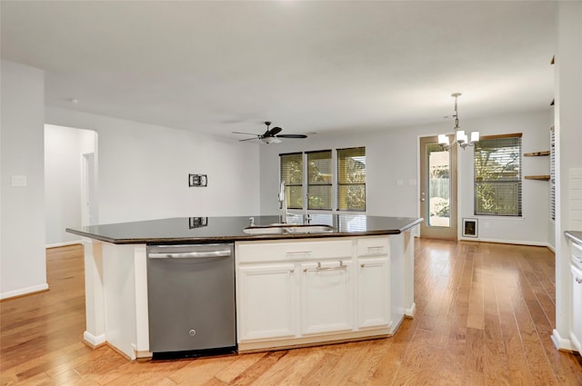 kitchen with white cabinetry, dishwasher, a kitchen island with sink, and sink