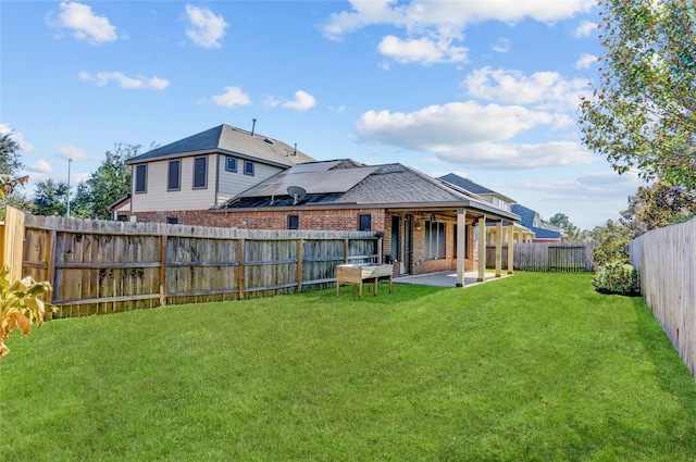 back of house with a yard and a patio