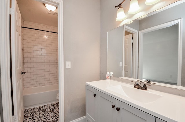 full bathroom featuring tile patterned floors, toilet, vanity, and tiled shower / bath