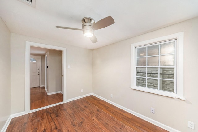 empty room with hardwood / wood-style floors and ceiling fan