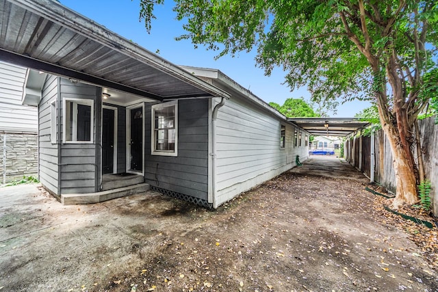 view of side of home with a carport