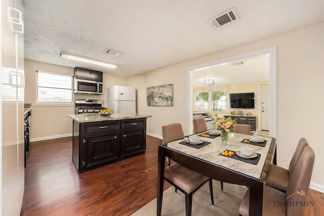 dining space featuring dark hardwood / wood-style floors