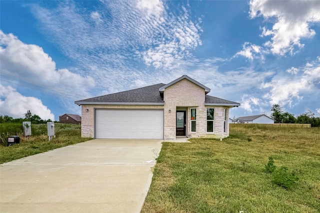 view of front of property featuring a garage and a front lawn