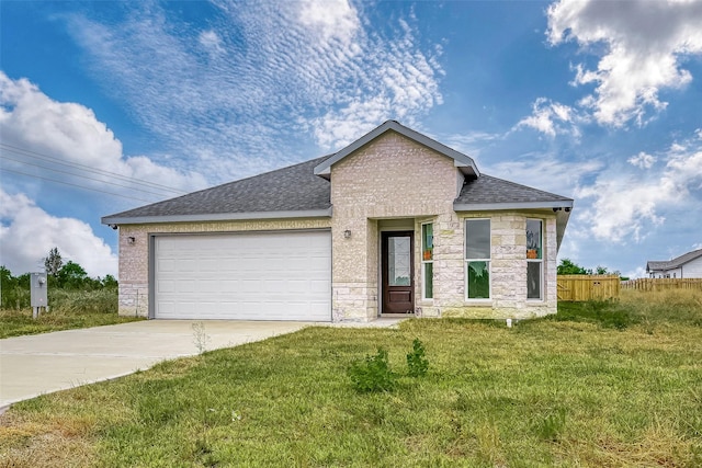 view of front facade featuring a garage and a front lawn