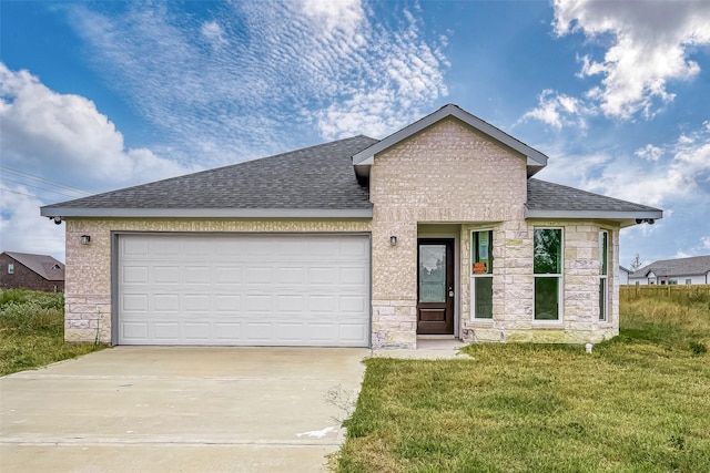 view of front of property with a front yard and a garage