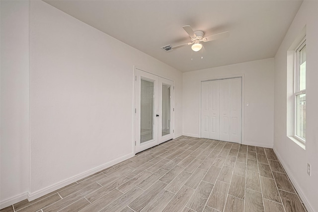 unfurnished bedroom featuring french doors, light wood-type flooring, a closet, and ceiling fan