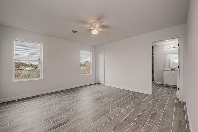 unfurnished room featuring ceiling fan and light hardwood / wood-style flooring