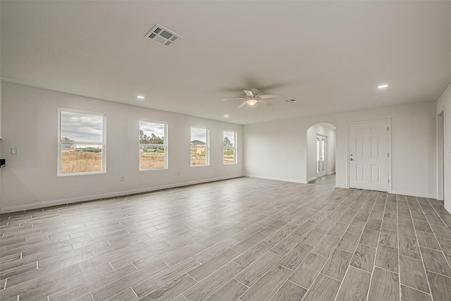 unfurnished living room with ceiling fan and light hardwood / wood-style flooring