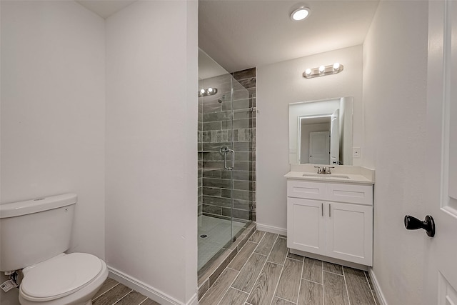 bathroom with vanity, toilet, and a shower with shower door