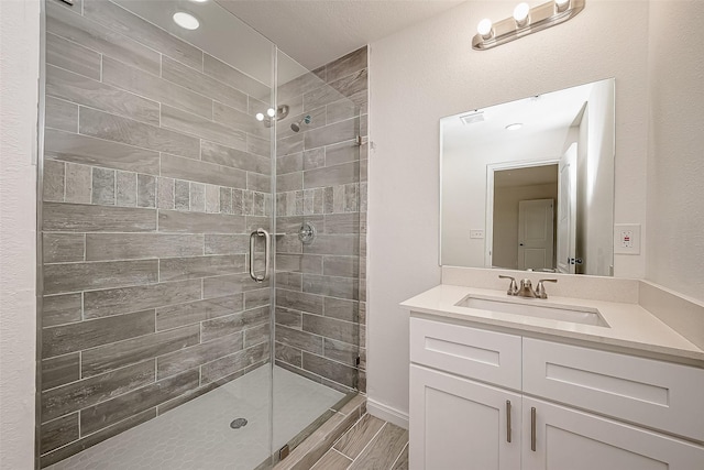 bathroom with vanity and a shower with shower door