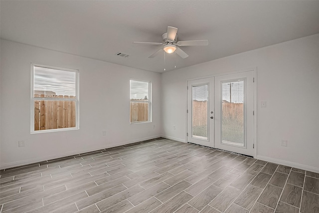 empty room featuring french doors, light hardwood / wood-style floors, and ceiling fan